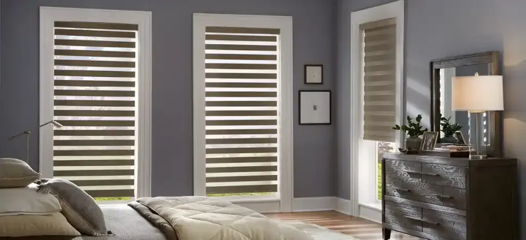 Bedroom with grey walls and windows dressed with dual shades