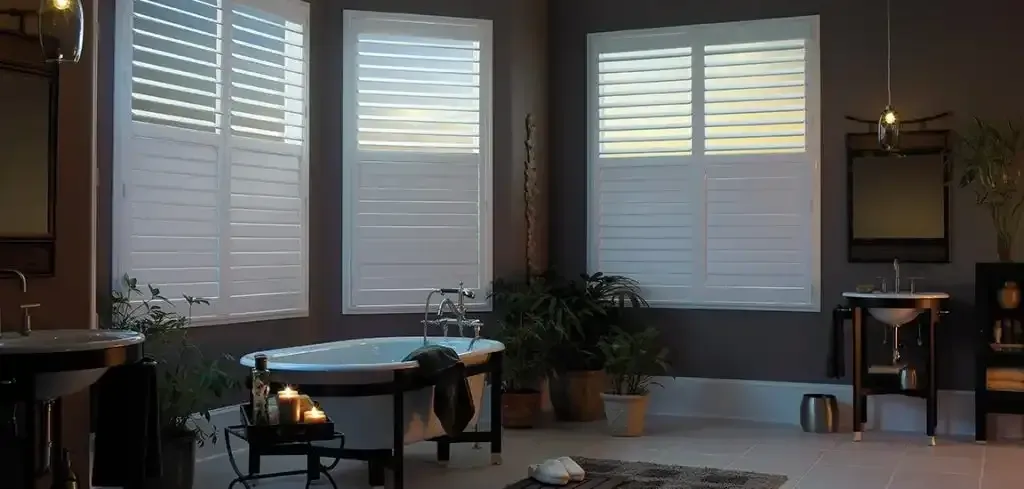 Bathroom with a bathtub, windows with shutters, and plants.